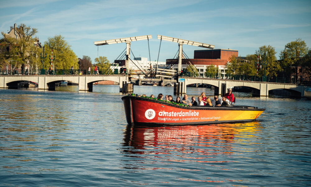 A boat tour on an Amsterdam canal. People enjoying the city from the water.
