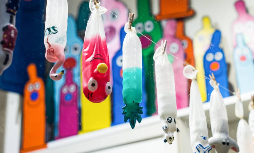 Condoms in different colours hanging on a line in the Condomerie in Amsterdam