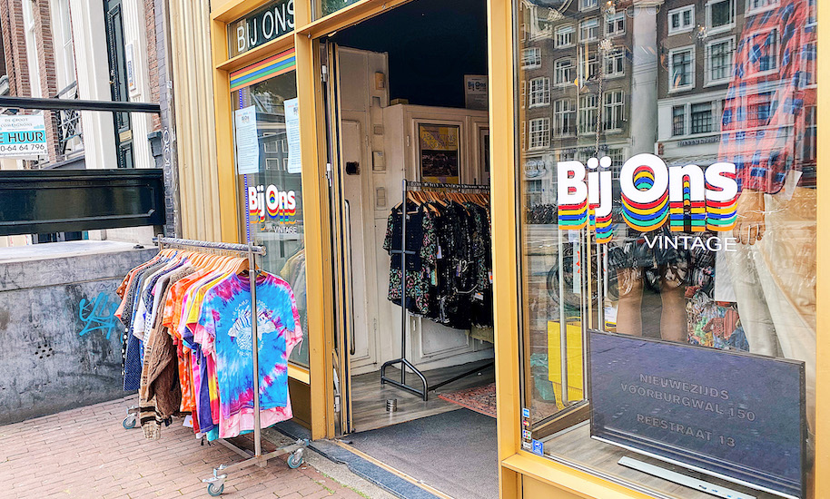 Entrance of Bij Ons Vintage Shop Amsterdam with colourful T-shirts