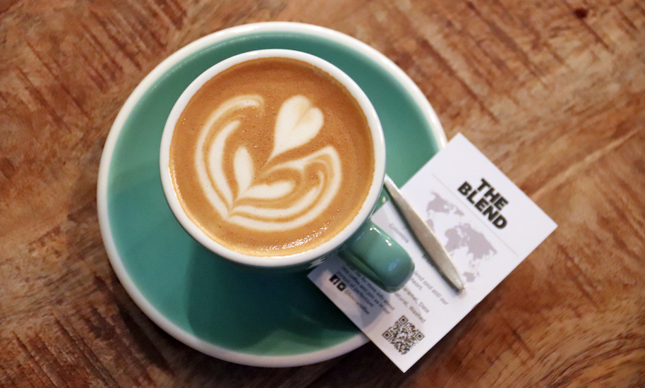 Beautifully decorated coffee in a mint green cup