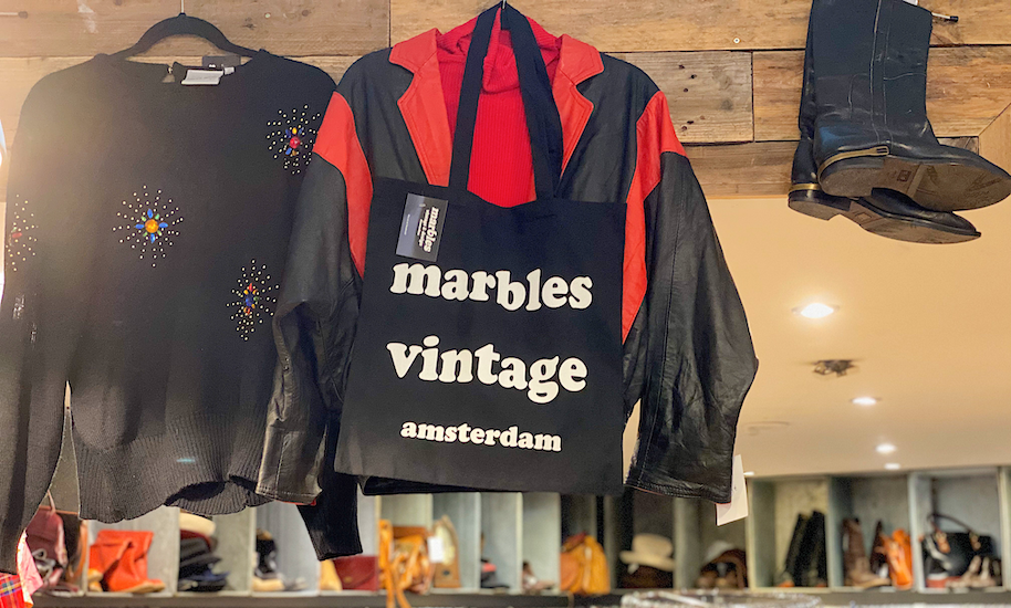 Black Marbels Vintage Amsterdam fabric bag hanging next to jumper and boots