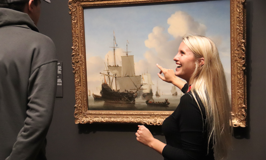 Tour guide from Amsterdamliebe points to a work of art in the Rijksmuseum Amsterdam