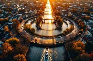 Aerial view of a round waterway in Amsterdam with a boat. Cityscape with trees and buildings.